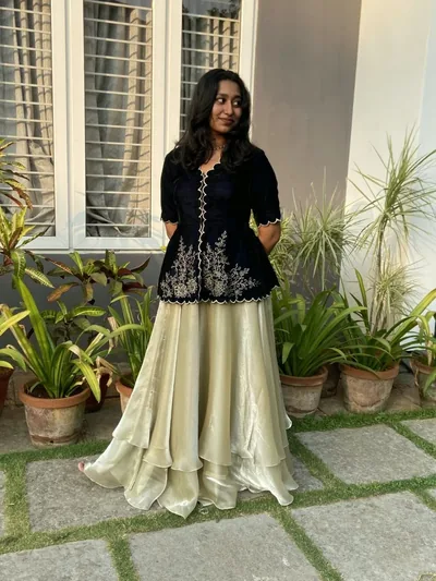 Black velvet peplum and layered ivory skirt in a garden